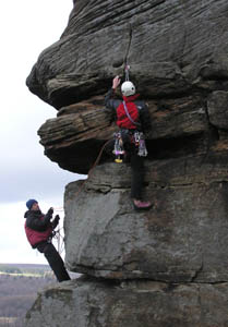 John helping a leader on Froggatt Pinnacle. Photo: Tony Stock 